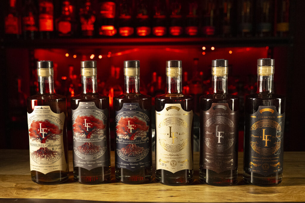 LF Heritage Distilling Releases bourbon lineup on bar with red background