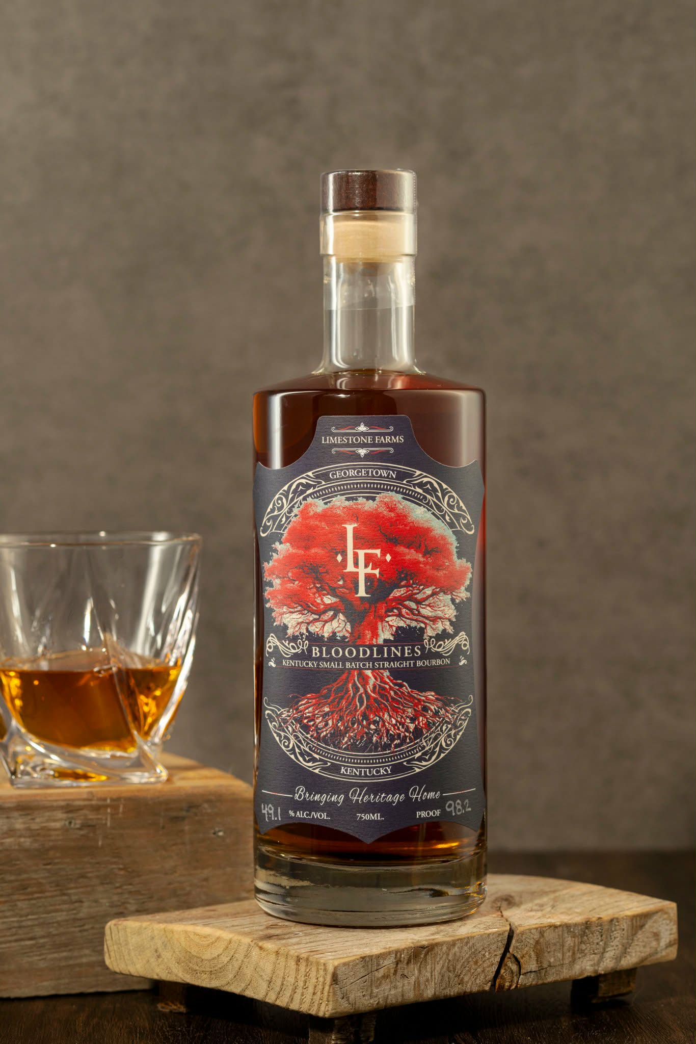 LF Heritage Distilling Bloodlines Small Batch bourbon bottle with tasting glass